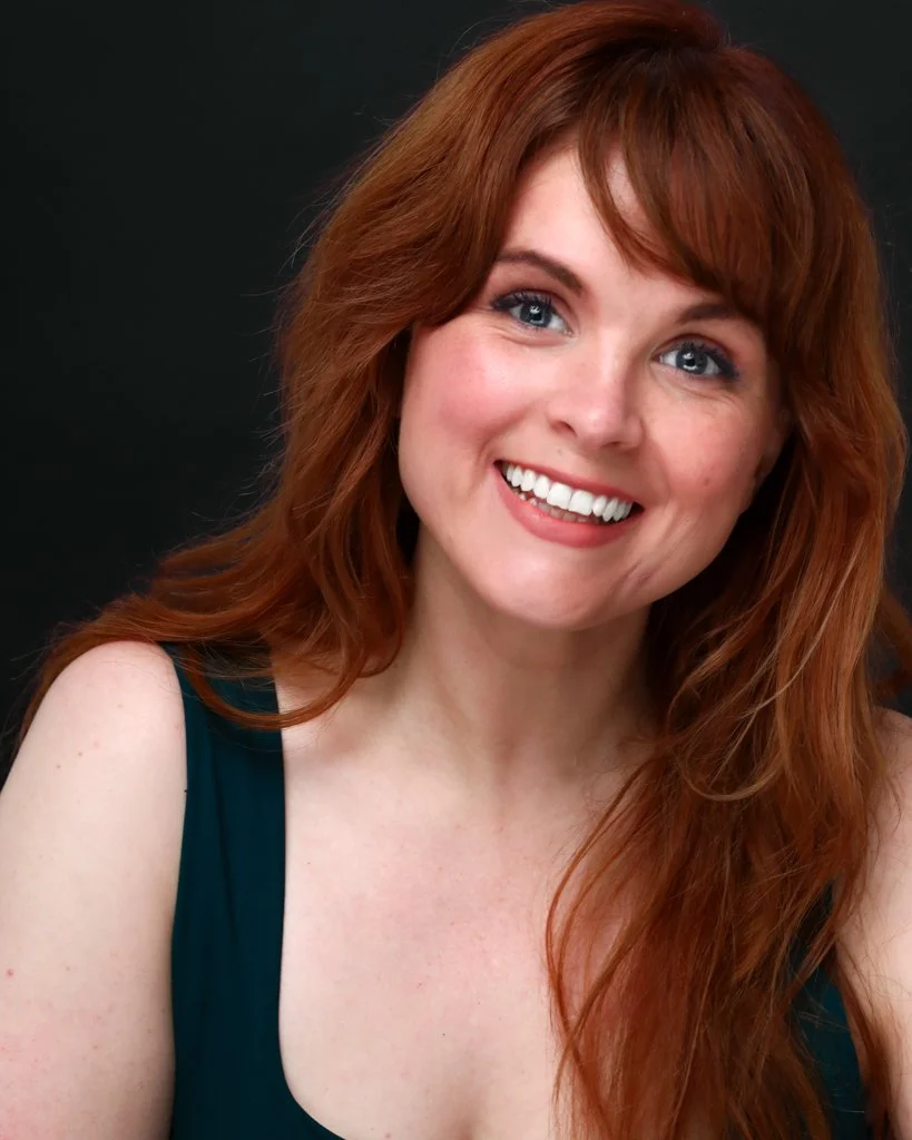 Blaire Erskine headshot in red.