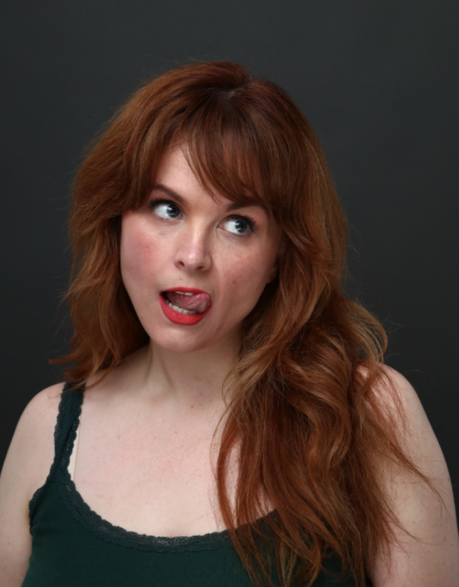 Blaire Erskine making a silly face in a green top.