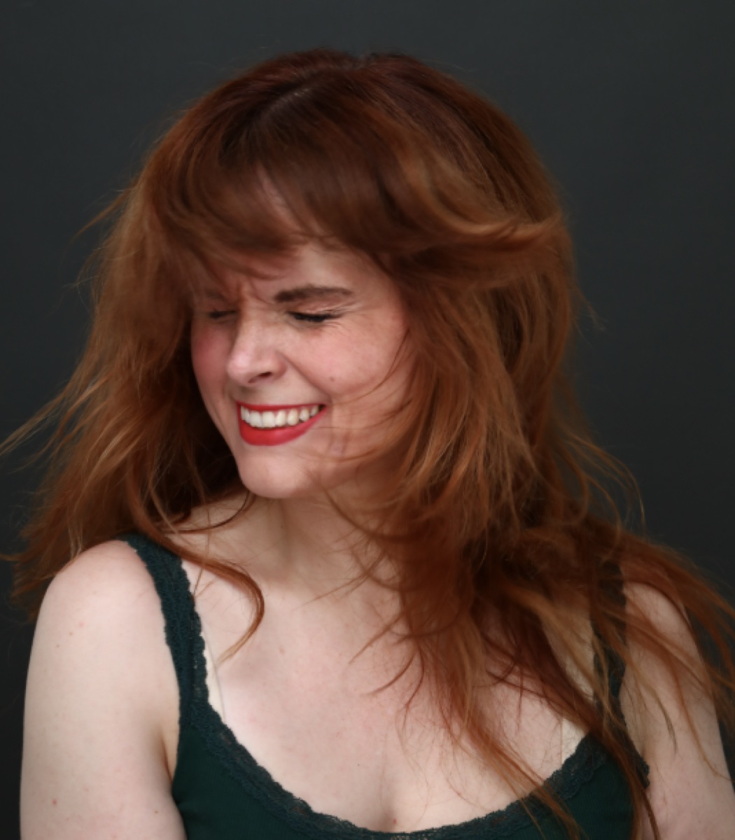 Blaire Erskine laughing in a green top.