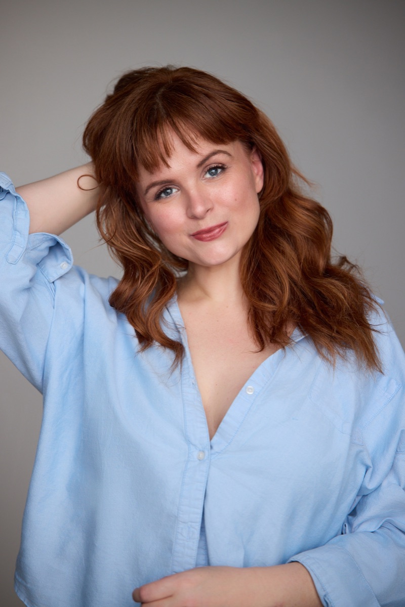 Blaire Erskine in a light blue button-down shirt.